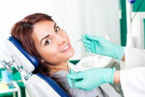 Woman smiling in dentist's chair.