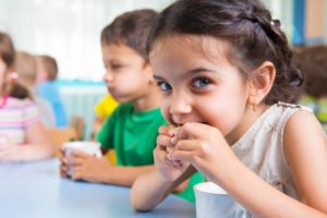 Girl smiling and eating